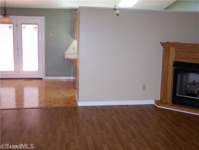 Living Room. Large and roomy great room that features picture windows, gas logs, ceiling fans, and opens nicely into the dining area and kitchen!