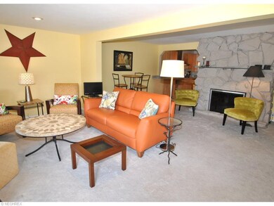 A cozy eating area and stone fireplace grace the l