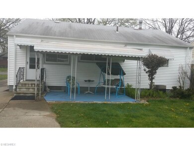 covered patio in rear fenced in yard that is large