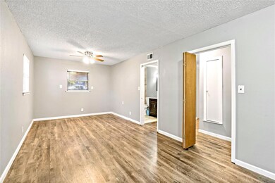 Unfurnished room featuring ceiling fan, a textured