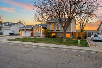 Tri-level home featuring brick siding and concrete driveway