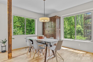 Open dining area. Chinese storage cabinet conveys.