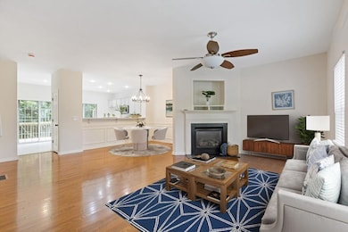 Enjoy an Open Concept layout with Hardwood Floors, Tall Ceilings, and a Fireside Family Room that flows right into the Dining Area, complete with Picture Frame Wainscoting