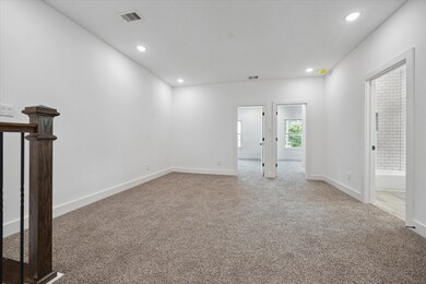 The upstairs living area features plush carpet, re