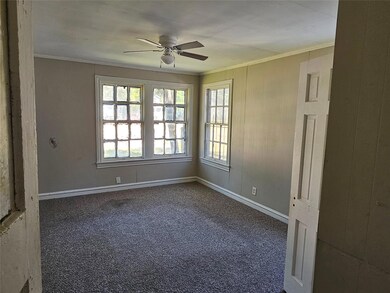 Carpeted spare room featuring crown molding and ce