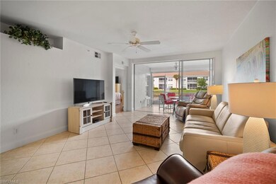 Tiled living room featuring ceiling fan
