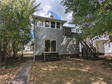 Back of house featuring a chimney
