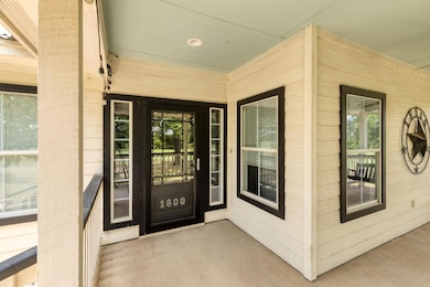Doorway to property with covered porch