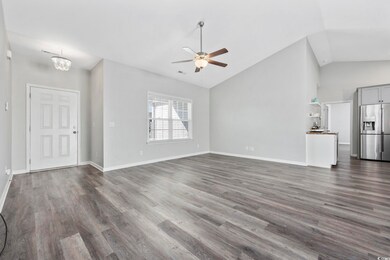 Unfurnished living room with ceiling fan with nota