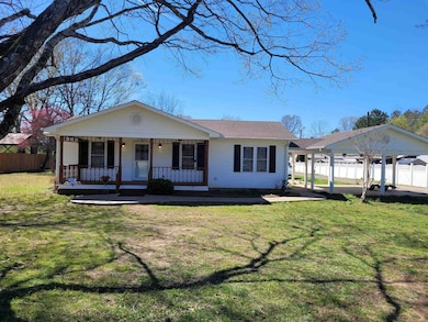View of front of property featuring fence, a porch