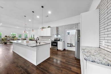 Kitchen featuring a sink, decorative backsplash, e