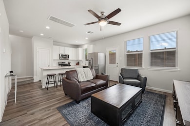 Open-concept living area with ceiling fan, and lar