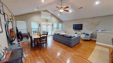 Living room with wood-type flooring, high vaulted 