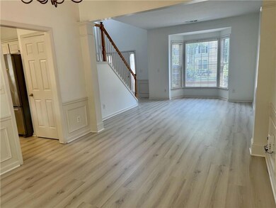 Unfurnished room featuring stairway and light wood-type flooring