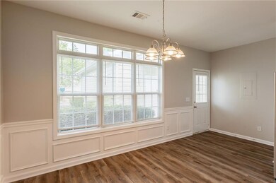 Unfurnished dining area featuring a decorative wal
