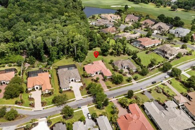Aerial view of property and surrounding area featuring nearby suburban area and a nearby body of water