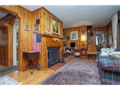 Living room: Wood paneling, wood flooring,gas fire