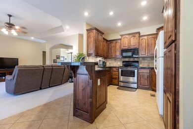 Well laid out kitchen space with warm color stained cabinetry.