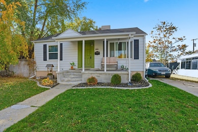 Bungalow-style house featuring covered porch and a front yard