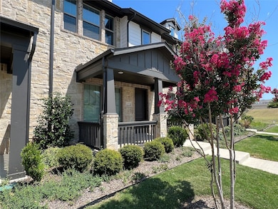 Entrance to property featuring stone siding, a porch, board and batten siding, and a yard