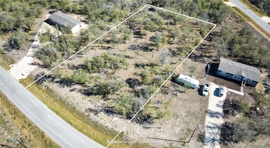 Aerial view of property and surrounding area featuring property parcel outlined