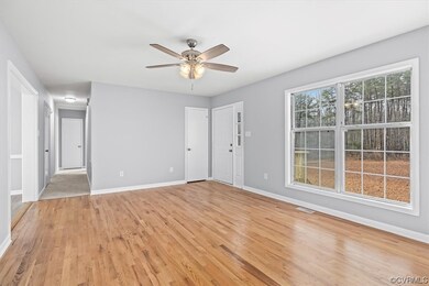 Living room with light hardwood flooring and ceili
