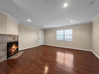 Unfurnished living room with  dark hardwood / wood-style floors, and a tiled fireplace