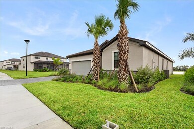 View of side of home featuring driveway, a yard, a