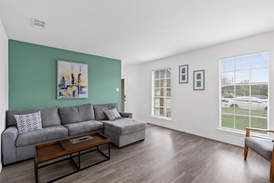 Living area featuring wood finished floors and pl