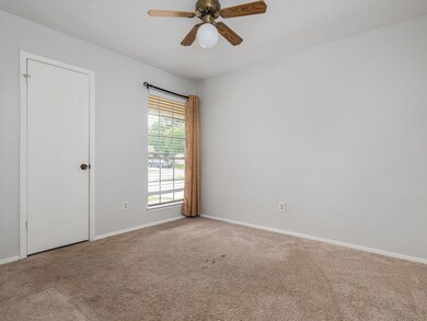 Spare room with carpet floors and a ceiling fan
