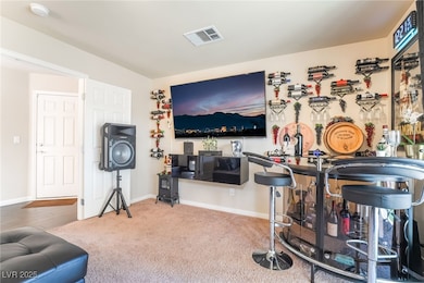Bar area with baseboards and carpet flooring