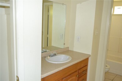 Full bath featuring vanity, tile patterned floorin