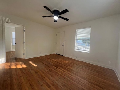 Empty room featuring dark wood finished floors an
