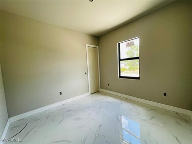 Spare room with baseboards and light marble finish