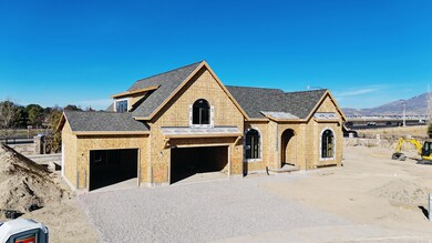 View of front of property with a shingled roof, gravel driveway, a garage, and a mountain view