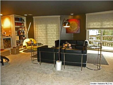 Living Room with fireplace, bookcases, two large g