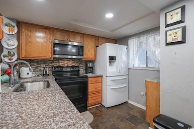 Kitchen featuring black range with electric cookto