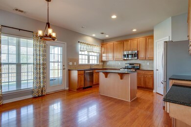 Spacious kitchen with stunning cabinetry complimented by beautiful hardwoods