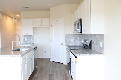 Kitchen with stainless steel appliances, a sink, 
