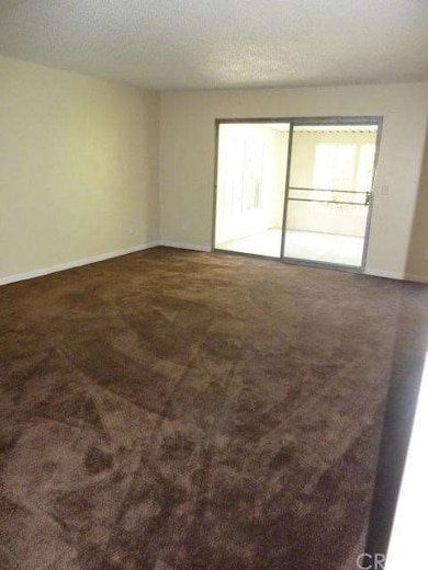 Large living room with two sliders to enclosed pat