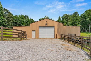 Detached garage with gravel driveway