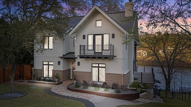 View of front facade featuring a balcony, metal r