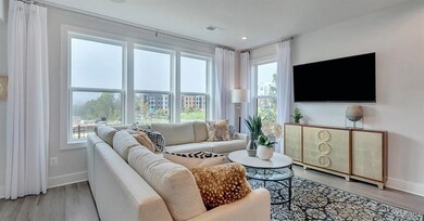Living area with baseboards, visible vents, and li