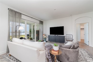 Living room with light wood finished floors and ba