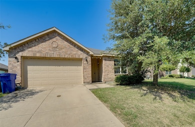Ranch-style home featuring an attached garage, brick siding, concrete driveway, and a front lawn