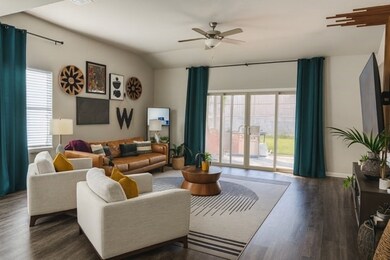 Living room featuring dark wood-style floors and ceiling fan
