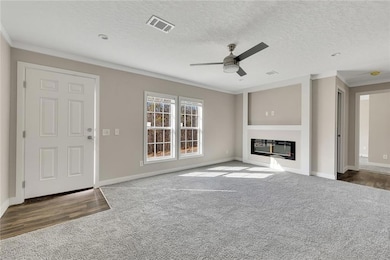 Unfurnished living room featuring ornamental moldi