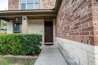 Doorway to property with brick siding