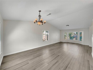 Spare room with a chandelier, wood finished floors