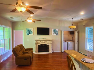 Living area featuring washer and dryer, a fireplac
